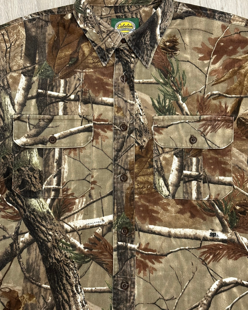 
                  
                    Vintage Cabela's RealTree AP Camo Button-Up Shirt - Size M Tall
                  
                